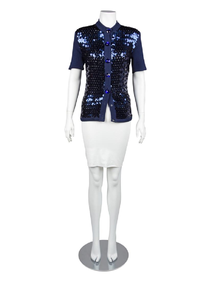 Yves Saint Laurent Top, 1990-2000s: Yves Saint Laurent Top, 1990-2000s Blue cotton knit top with crew neckline, short sleeves and a center front blue faceted button closure. The front panels are covered entirely with blue sequins. Label