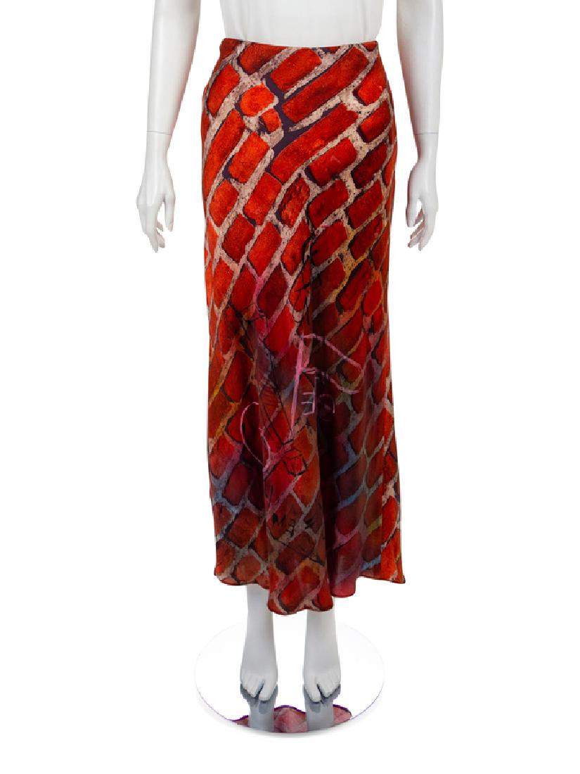 Moschino Brick Print Skirt, 1997: Moschino Brick Print Skirt, 1997 Long bias-cut silk satin skirt printed with a brick wall theme with black and pink graffiti featuring the words 'Moschino' and 'Peace'. The skirt closes with a side se