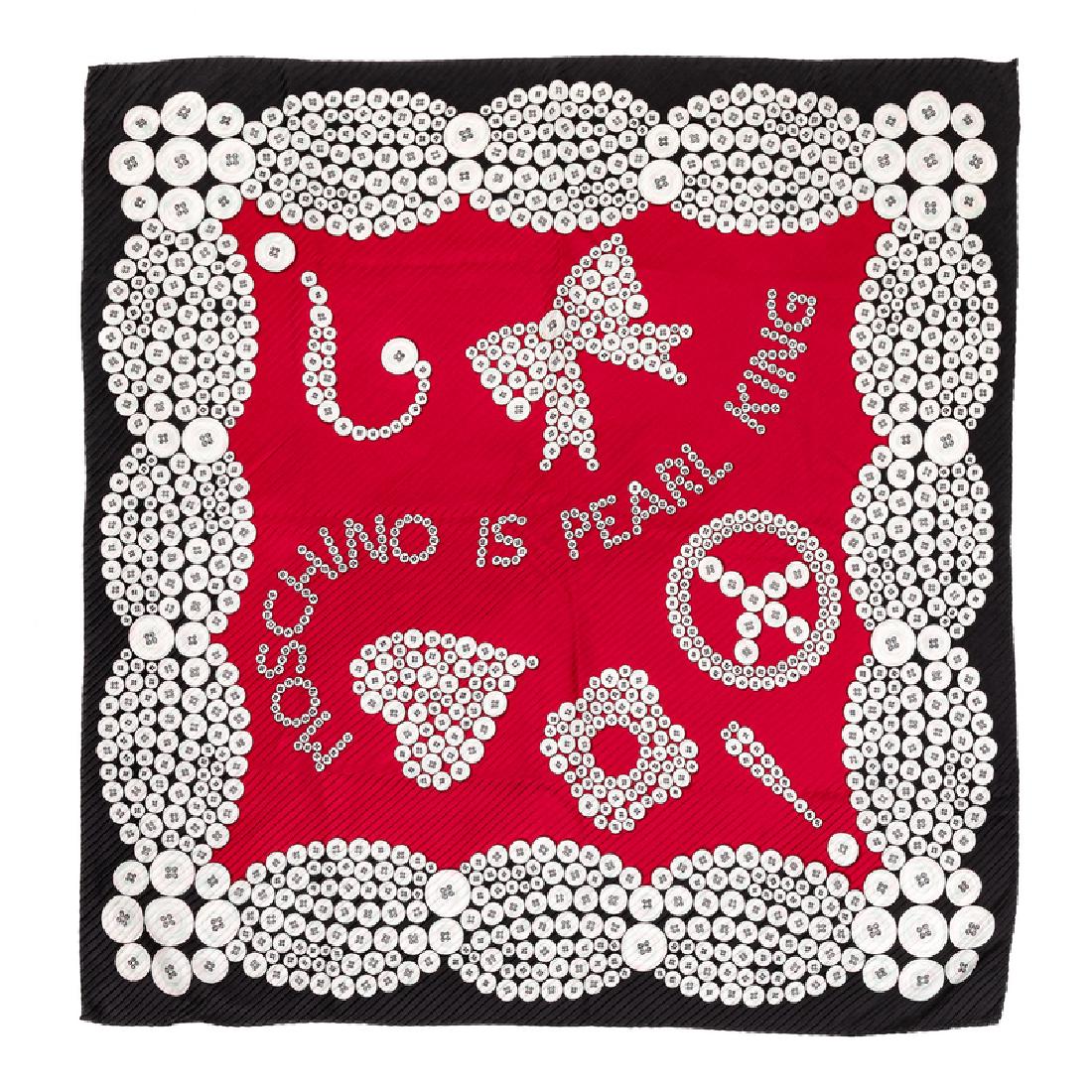 Moschino 'Pearl King' Scarf, 1980-90s: Moschino 'Pearl King' Scarf, 1980-90s Pleated silk scarf printed with white buttons that form the words 'MOSCHINO IS PEARL KING'. Black border with a red center. Labeled within the print: Moschino App