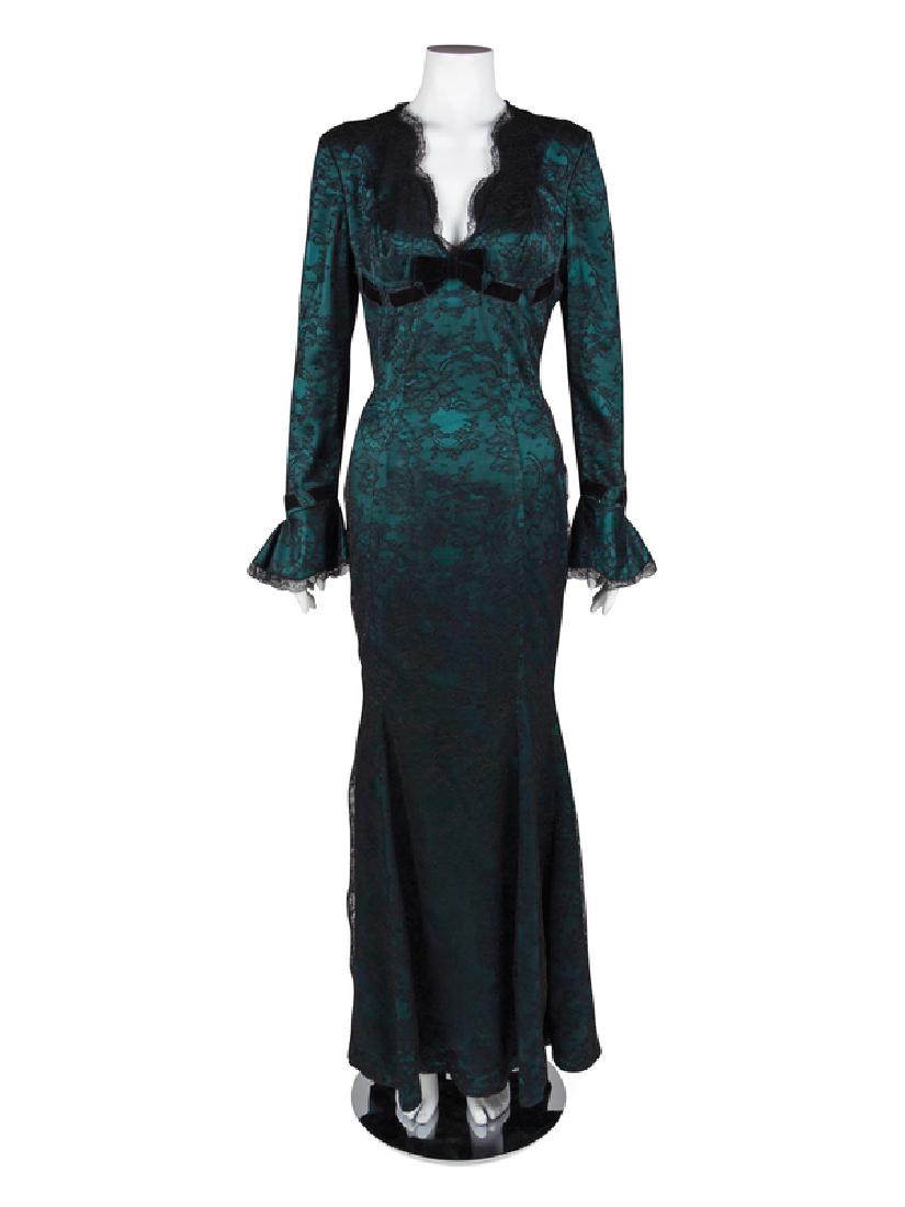 Thierry Mugler Dress, 1990s: Thierry Mugler Dress, 1990s Long, form-fitted dress of green satin covered in black lace and trimmed with black velvet ribbon. The dress is cut with vertical panels that extend into a flared hem and n