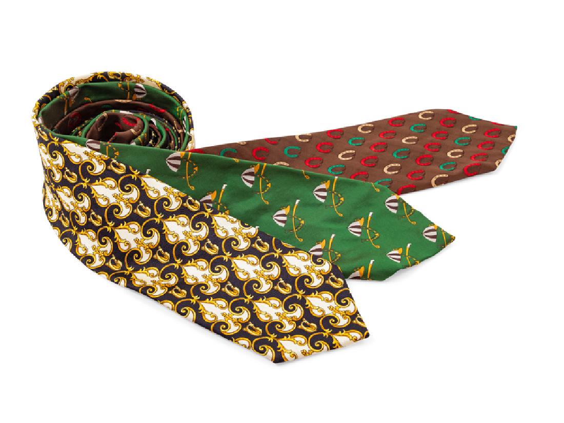 Two Gucci and One Versace Ties: Two Gucci and One Versace Ties The first: Black, yellow and white design. The second: Green with jockey accessories. The fourth: Brown with horseshoe design. Condition: Overall good condition. Wear co