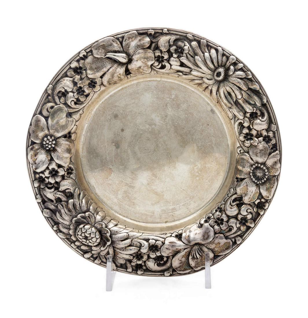 An American Silver Wine Coaster Gorham Mfg. Co: An American Silver Wine Coaster Gorham Mfg. Co., Providence, RI, 1898 the rim worked with repousse floral decoration. marked 'Sterling' on underside 4 ozt 10 dwts Diameter 6 3/4 inches.