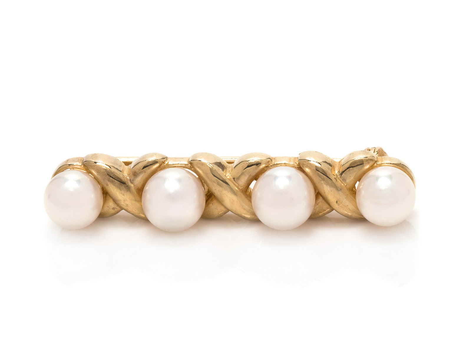 A 14 Karat Yellow Gold and Cultured Pearl Brooch,: A 14 Karat Yellow Gold and Cultured Pearl Brooch, Mikimoto, containing four pearls measuring approximately 5.70-6.10 mm in diameter. Stamp: 14K HK M. 3.20 dwts.
