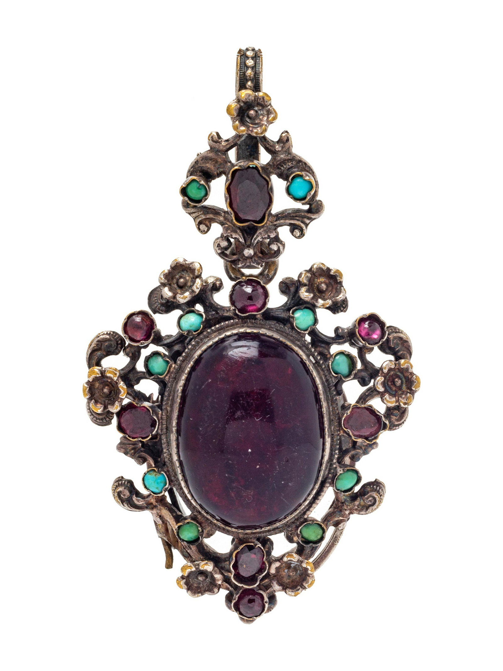 An Antique Silver, Garnet and Turquoise Locket: A Silver, Garnet and Turquoise Locket, containing a center oval cabochon garnet as well as 8 garnets of varying size and shape and 10 round cabochon turquoise in a floral motif pendant with glass back