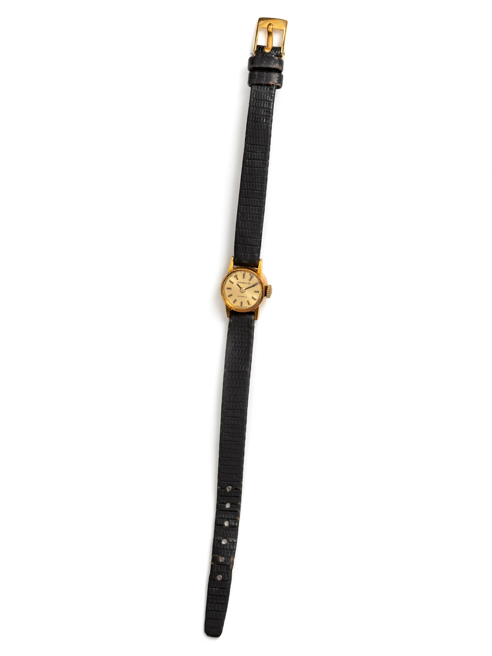 An 18 Karat Yellow Gold Wristwatch. Tiffany and Co.,: An 18 Karat Yellow Gold Wristwatch. Tiffany and Co., 14.00 mm case diameter, matte silvered dial signed TIFFANY & CO, black and gold baton numerals, black sword hands, snap on case back, automatic mov