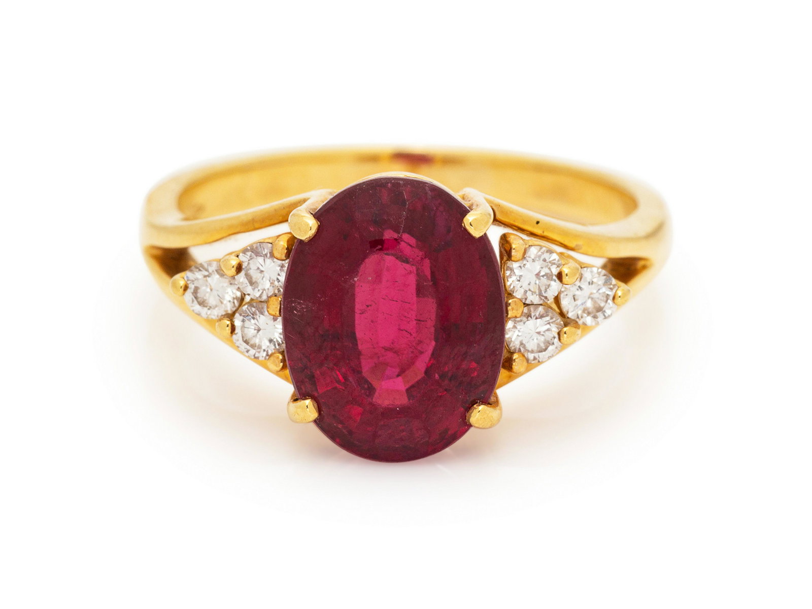 An 18 Karat Yellow Gold Rubelite Tourmaline and Diamond: An 18 Karat Yellow Gold Rubelite Tourmaline and Diamond Ring, containing one oval mixed cut tourmaline measuring approximately 6.85 x 8.30 x 6.10 mm and six round brilliant cut diamonds weighing appro