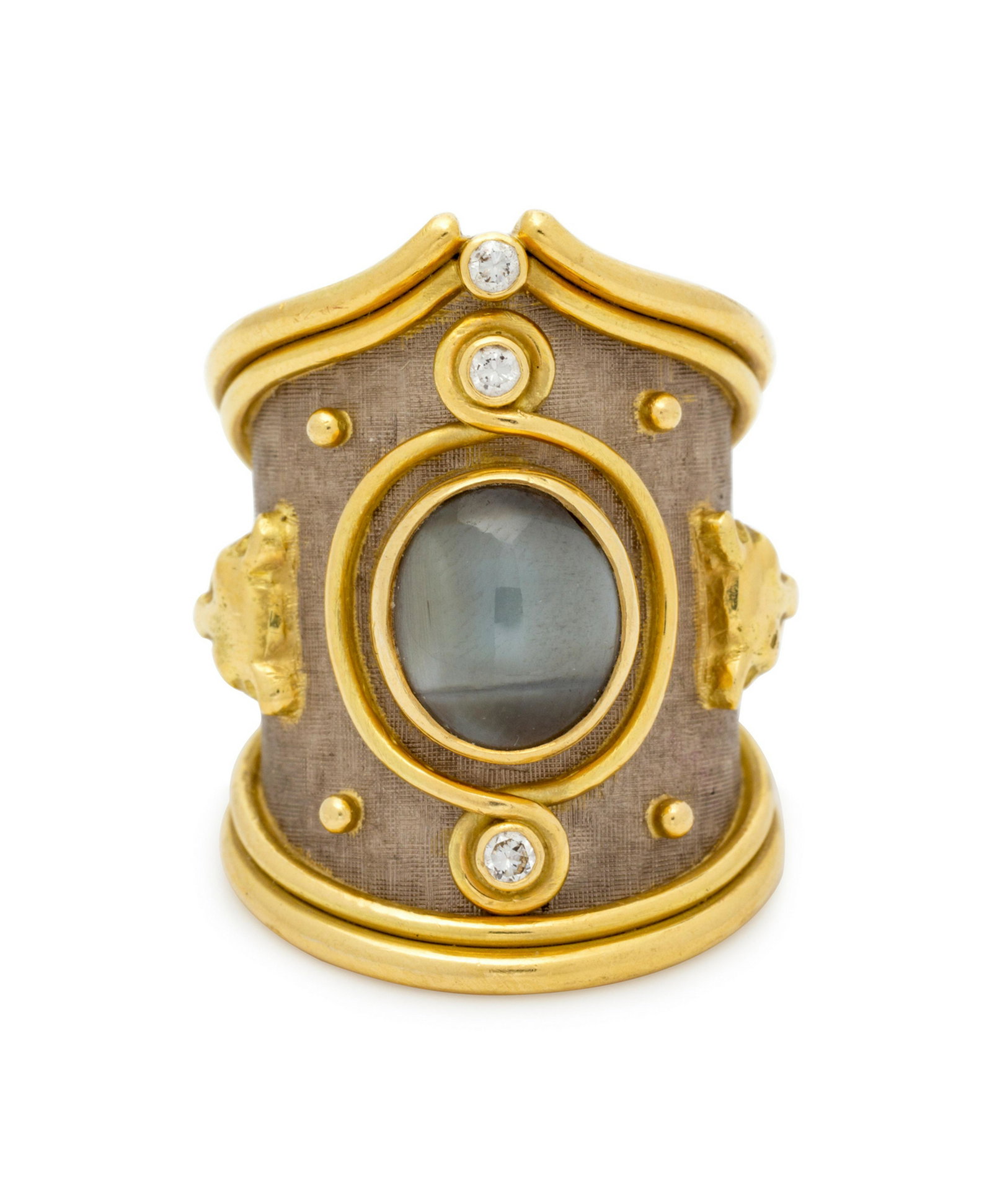 An 18 Karat Bi-Color Cat's Eye Chrysoberyl and Diamond: An 18 Karat Bi-Color Cat's Eye Chrysoberyl and Diamond Ring, Elizabeth Gage, containing one oval cabochon cat's eye chrysoberyl measuring approximately 9.55 x 8.30 x 4.70 mm and three round brilliant 
