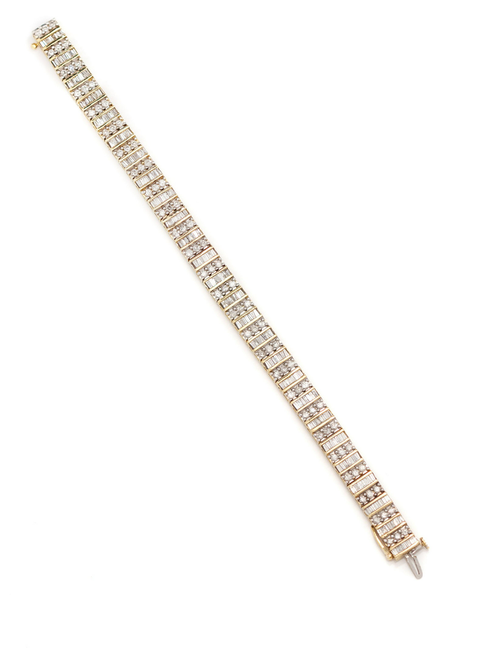 A 14 Karat Yellow Gold and Diamond Bracelet,: A 14 Karat Yellow Gold and Diamond Bracelet, containing 182 baguette cut diamonds and 78 round brilliant cut diamonds weighing approximately 3.35 carats total. Stamp: 14K. 16.85 dwts.