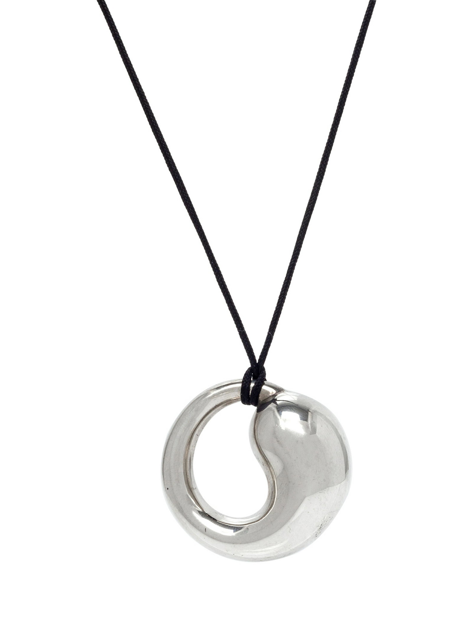 A Sterling Silver and Cord 'Eternal Circle' Necklace,: A Sterling Silver and Cord 'Eternal Circle' Necklace, Elsa Peretti for Tiffany & Co., measuring approximately 33.00 mm wide. Stamp: TIFFANY & Co. PERETTI STERLING SPAIN 925. 8.70 dwts. Accompanied by 