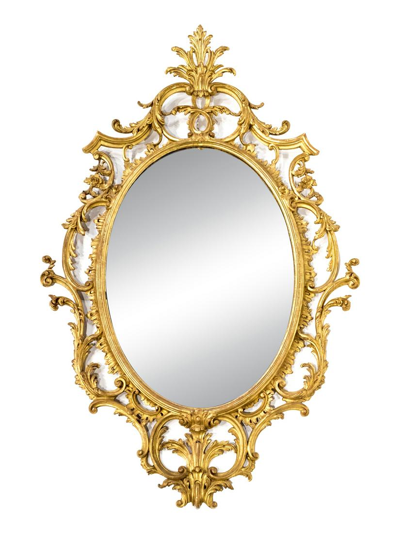 A George III Style Giltwood Mirror: A George III Style Giltwood Mirror The shaped rectangular mirror plate within an elaborate pierce-carved frame with foliate cresting. Height 45 x width 29 inches Provenance:Property from an Atlanta Pr