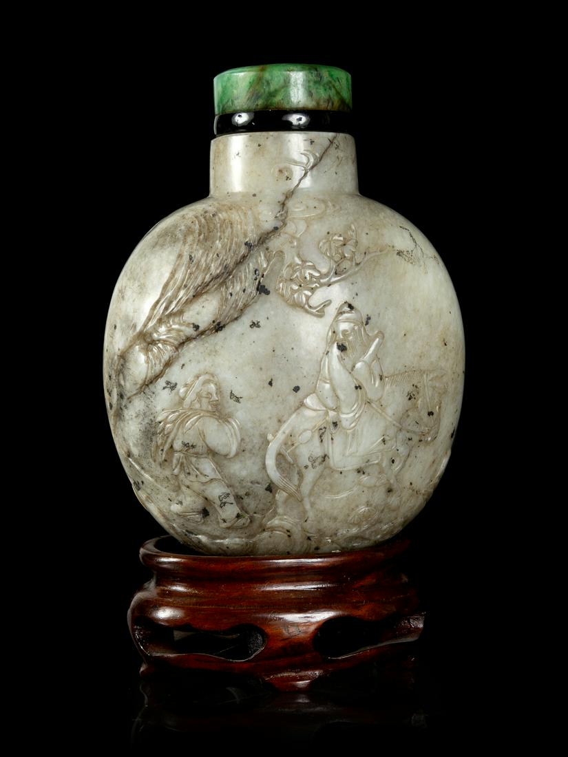 A Large Chicken Bone Jade Snuff Bottle Height 3 in., 8: A Large Chicken Bone Jade Snuff Bottle 18TH CENTURY of flattened baluster form, carved in relief showing a continuing scene with a scholar carrying a qin, riding on a donkey, followed by his attendant