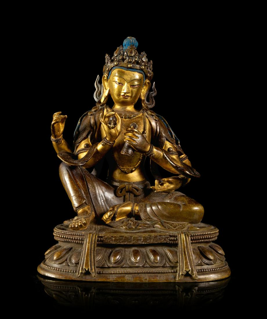 A Sino-Tibetan Gilt Bronze Figure of a Four-Armed: A Sino-Tibetan Gilt Bronze Figure of a Four-Armed Avalokitesvara Bodhisattva cast seated in lalitasana on a double-lotus base with beaded edges, wearing a dhoti and a loose shawl over the shoulder, a 