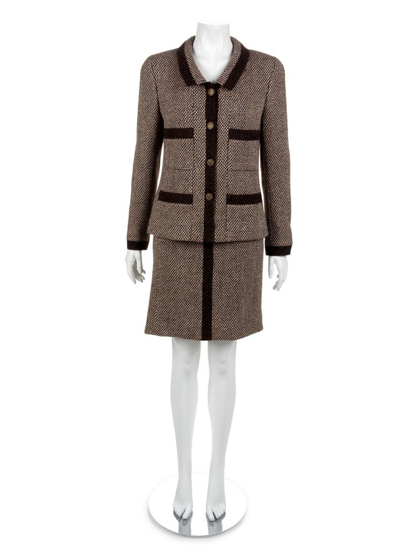 Chanel Skirt Suit, 1990-2000s: Chanel Skirt Suit, 1990-2000s Jacket and skirt made of brown and white wool trimmed with dark brown wool. The jacket has a fold down collar, long sleeves, patch pockets and a CC button closure. The sl