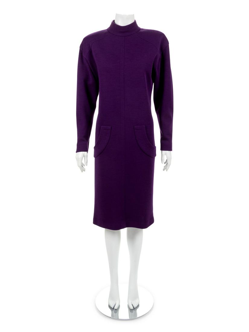 Givenchy Dress, 1980s: Givenchy Dress, 1980s Dress of purple wool knit with stand collar, shoulder pads, long sleeves and center back zip at neck. The front of the dress has three curved pocket flaps and the sleeve hems are