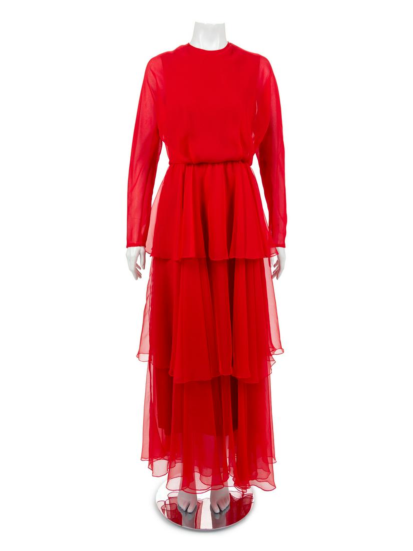 Two Evening Dresses: One Oscar de la Renta and One Joan: The first evening dress is red and made of layers of sheer red crepe with a scoop neckline, two sheer layers for the sleeves and a three tiered skirt. The dress closes down the center back with a zip.