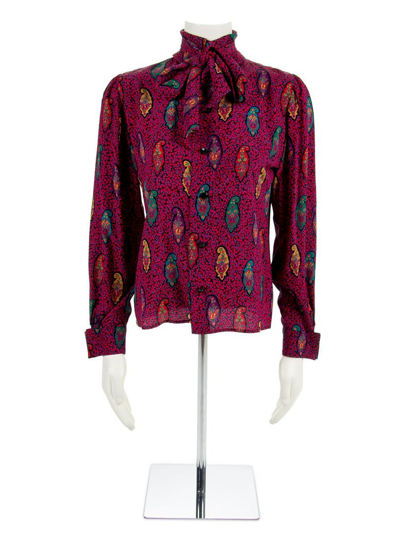Two Ungaro Blouses, 1980-90s: Two Ungaro Blouses, 1980-90s Red blouse with paisley print, self-fabric tie at neckline, long sleeves and a center front button closure. Label: Ungaro / Parallele / Paris Size Label: 6 Green blous