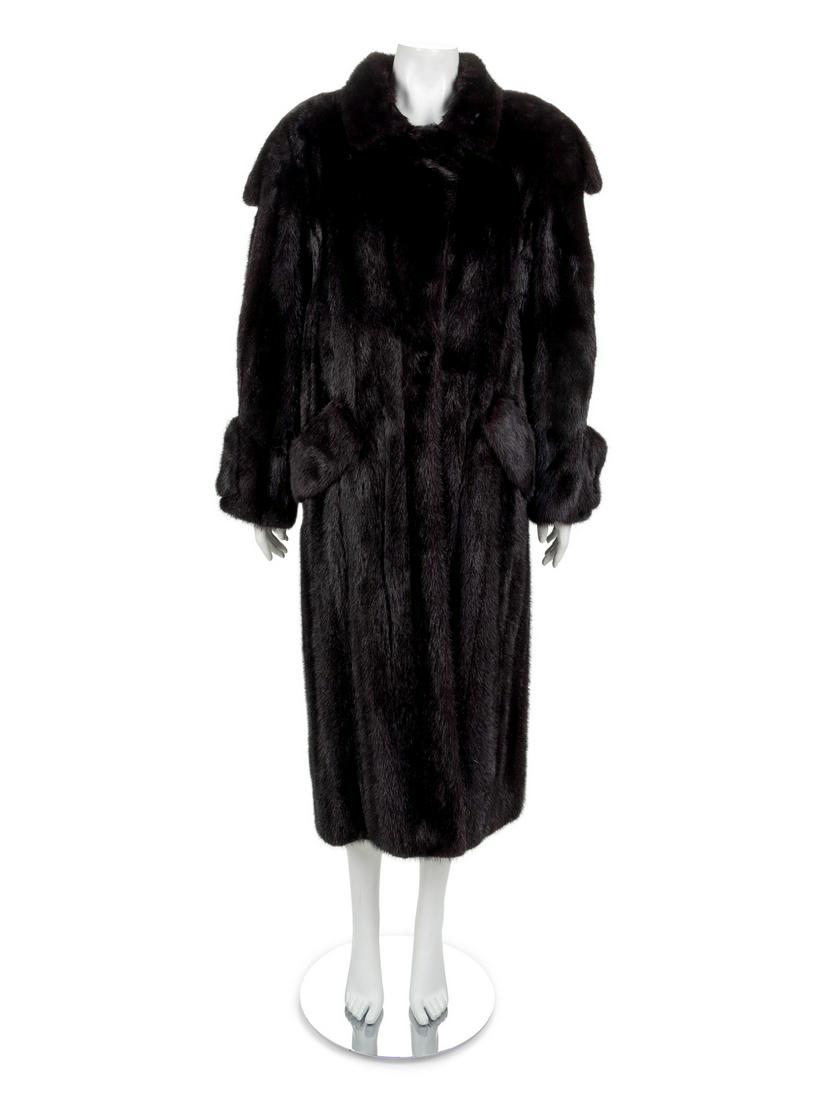 Long Mink Coat, 1990-2000s: Long Mink Coat, 1990-2000s Long black ranch mink coat with notched lapel, long sleeves and a center front closure. Coat is lined in black fabric. Provenance: