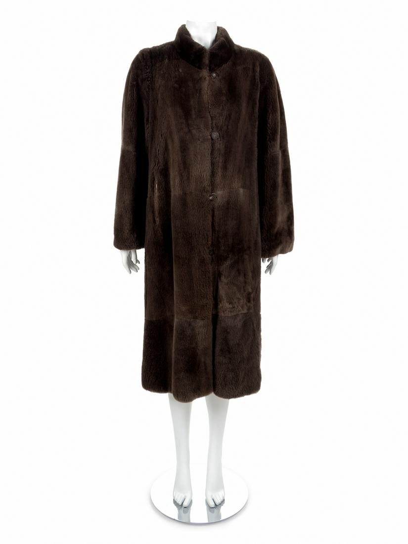 A Long Brown Fur Coat with button and loop closure,: A Long Brown Fur Coat with button and loop closure, 1970's-1980's Brown fur coat with stand collar, straight sleeves, leather loop and horn button front closure, and front pockets. Buttons inside of f