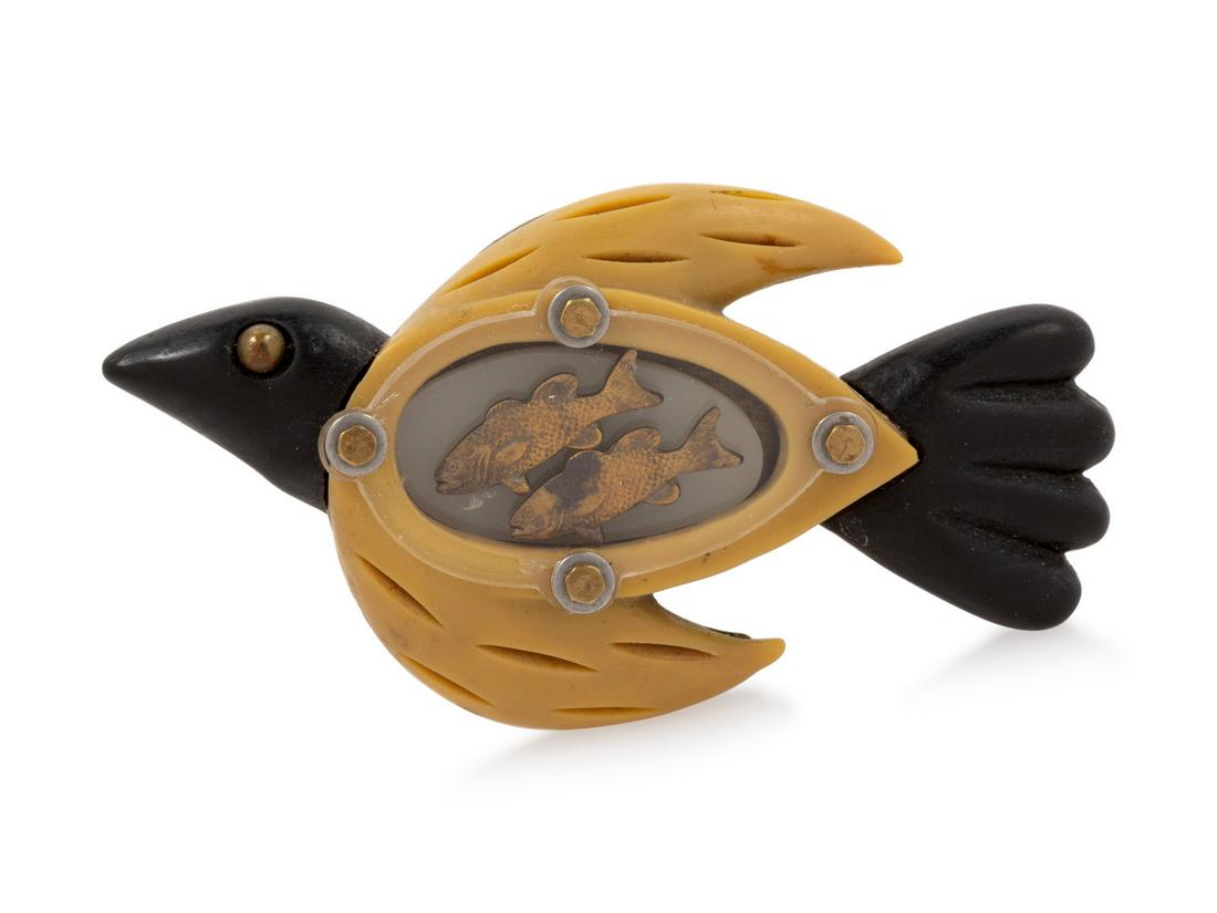 Techno-Romantic Bird Pin, 1990-2000s: Techno-Romantic Bird Pin, 1990-2000s Pin made in the profile of a bird in black and tan with a see-through window into the 'stomach', which contains two goldtone fish. Stamped: Techo-Romantic Handwr