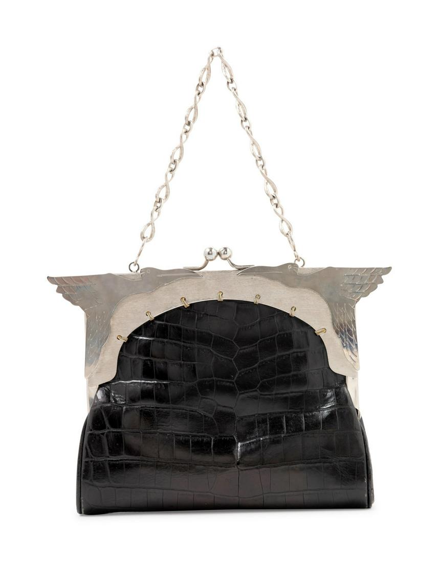John Galliano Handbag, c. 1996: John Galliano Handbag, c. 1996 Black with a silvertone frame with metal Pelican plaque, yellow interior lining with a top kiss lock closure and a short chain shoulder strap. Together with a matching b