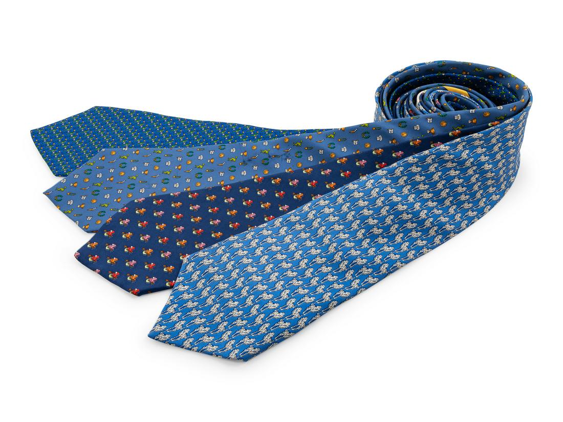 Four Salvatore Ferragamo Silk Ties,: Four Salvatore Ferragamo Silk Ties, the first; blue with olympic motif, the second; blue with cactus and cowboy motif, the third; blue with zebra motif, the fourth; blue with parrot motif. Each Labele