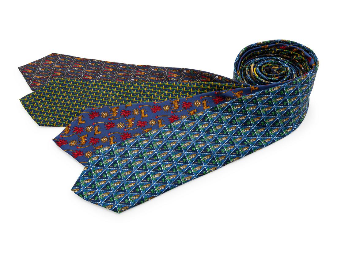 Four Salvatore Ferragamo Silk Ties,: Four Salvatore Ferragamo Silk Ties, the first; navy with soldiers in uniform motif, the second; blue with leopard and palm tree motif, the third; dark blue with leopard and red palm tree motif, the fo