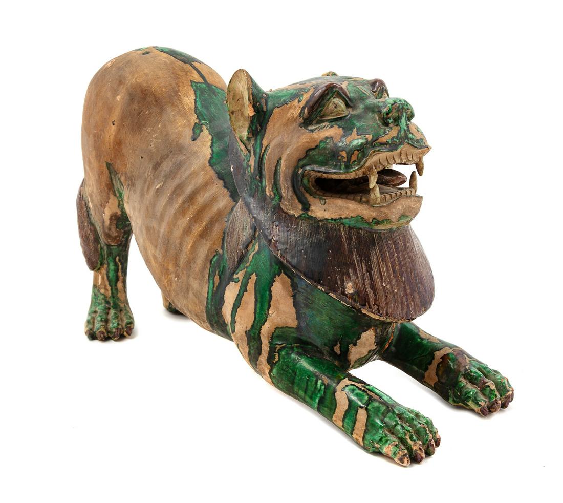 A Chinese Green and Straw Glazed Pottery Figure of a Fu (1 of 2)