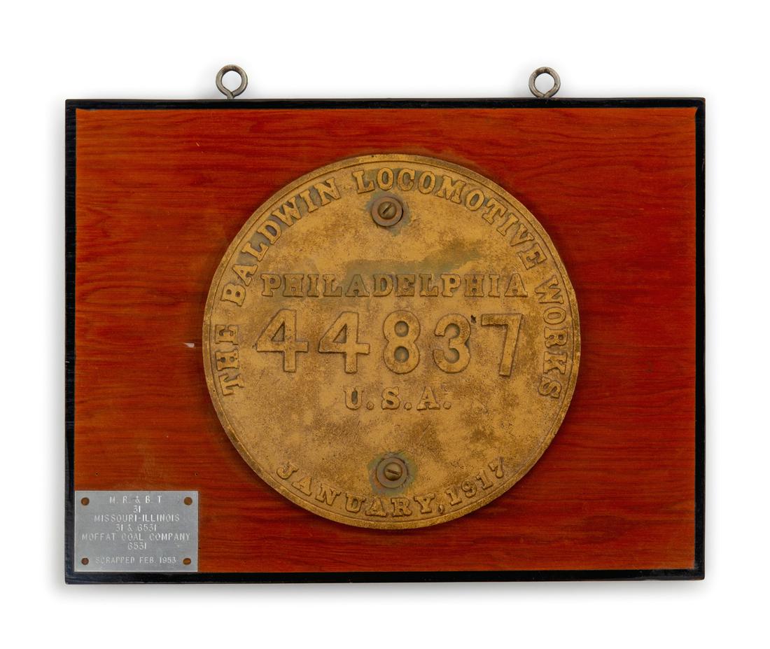 A Painted Metal Baldwin Locomotive Co.: Philadelphia: A Painted Metal Baldwin Locomotive Co.: Philadelphia Locomotive Badge and Engine Number Plaque for the M.R. & B.T. Railroad January, 1917 each mounted to one side of a wood plaque. Width overall 15 