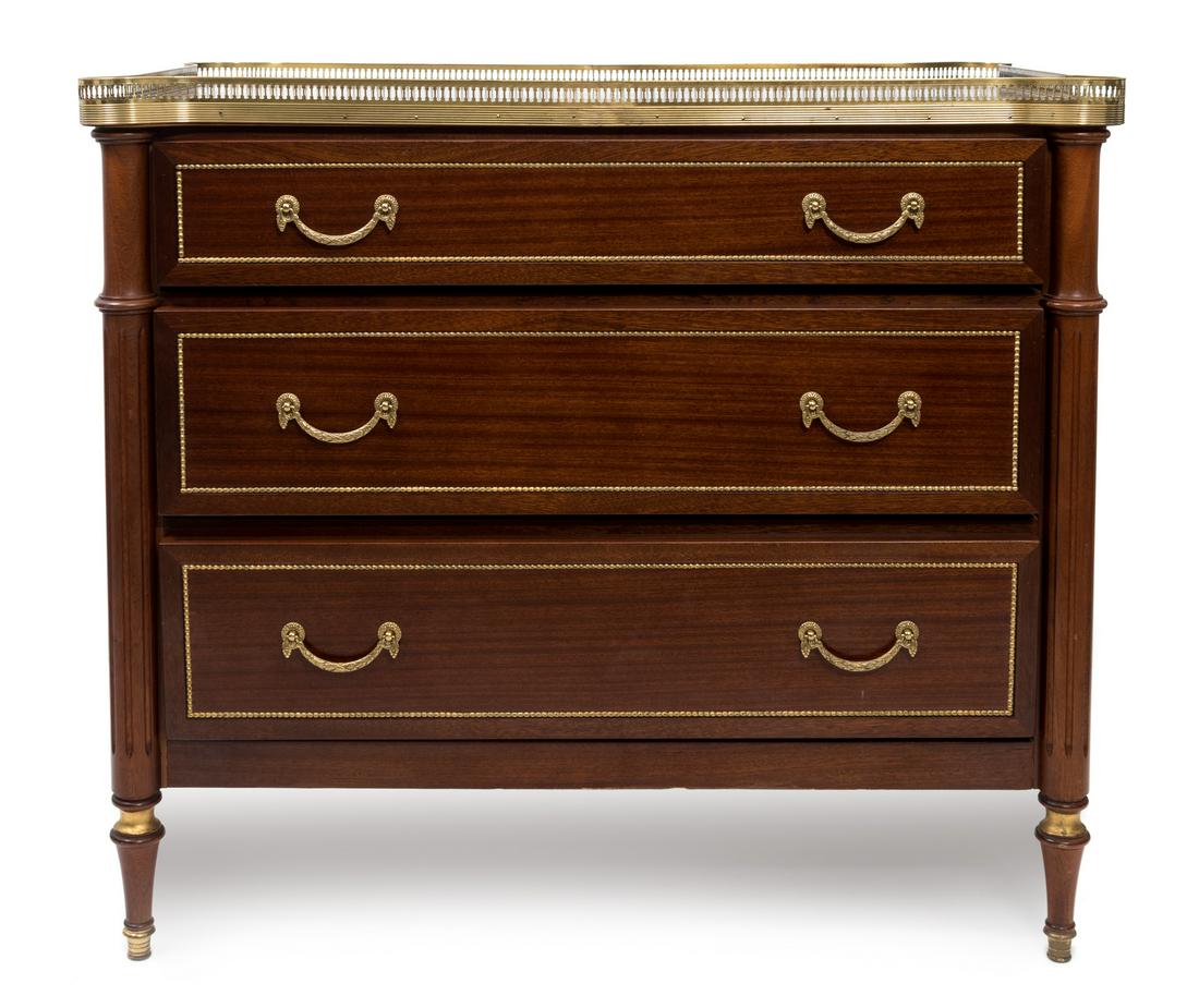 A Louis XVI Style Gilt Metal Mounted Mahogany Commode: A Louis XVI Style Gilt Metal Mounted Mahogany Commode LATE 19TH/EARLY 20TH CENTURY having a pierced gallery shaped top over three long drawers, raised on toupie feet. Height 35 x width 40 1/2 x depth 