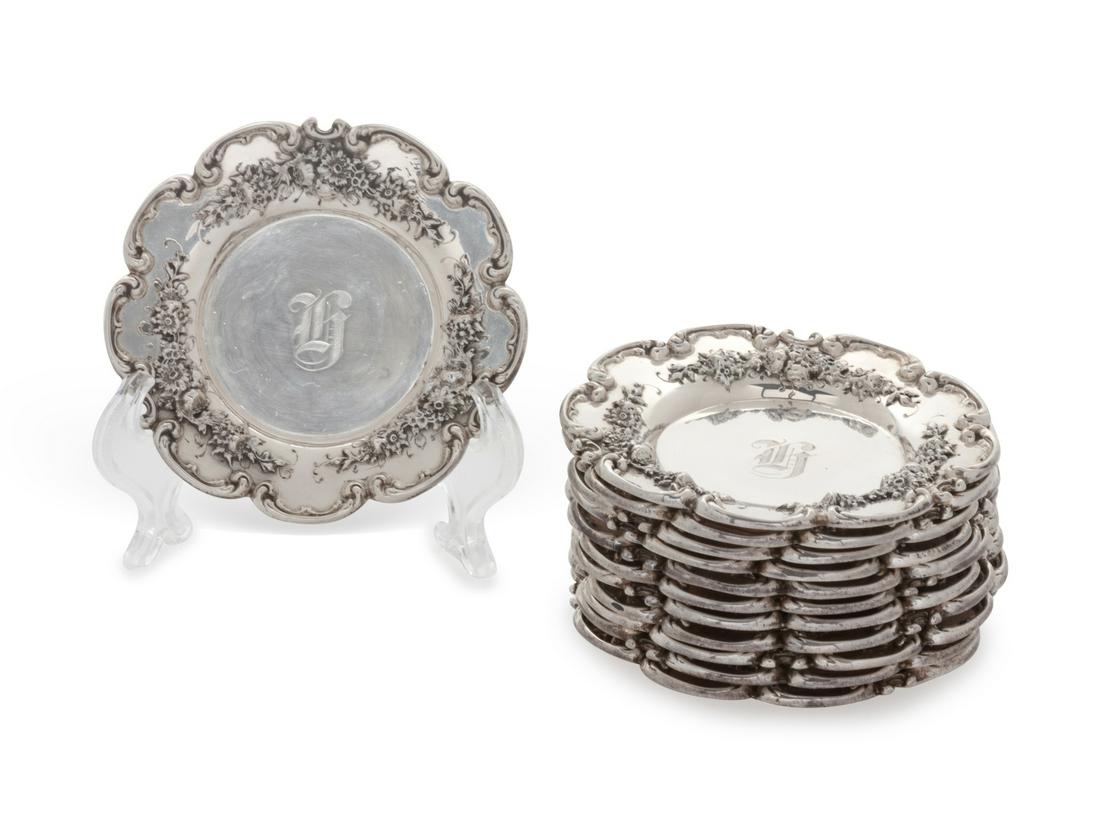 A Set of Twelve American Silver Butter Pats Redlich &: A Set of Twelve American Silver Butter Pats Redlich & Co., New York, NY each with floral decoration, monogrammed. marked 16 ozt Diameter 3 3/8 inches. Provenance: Property from the Collection of Tony 