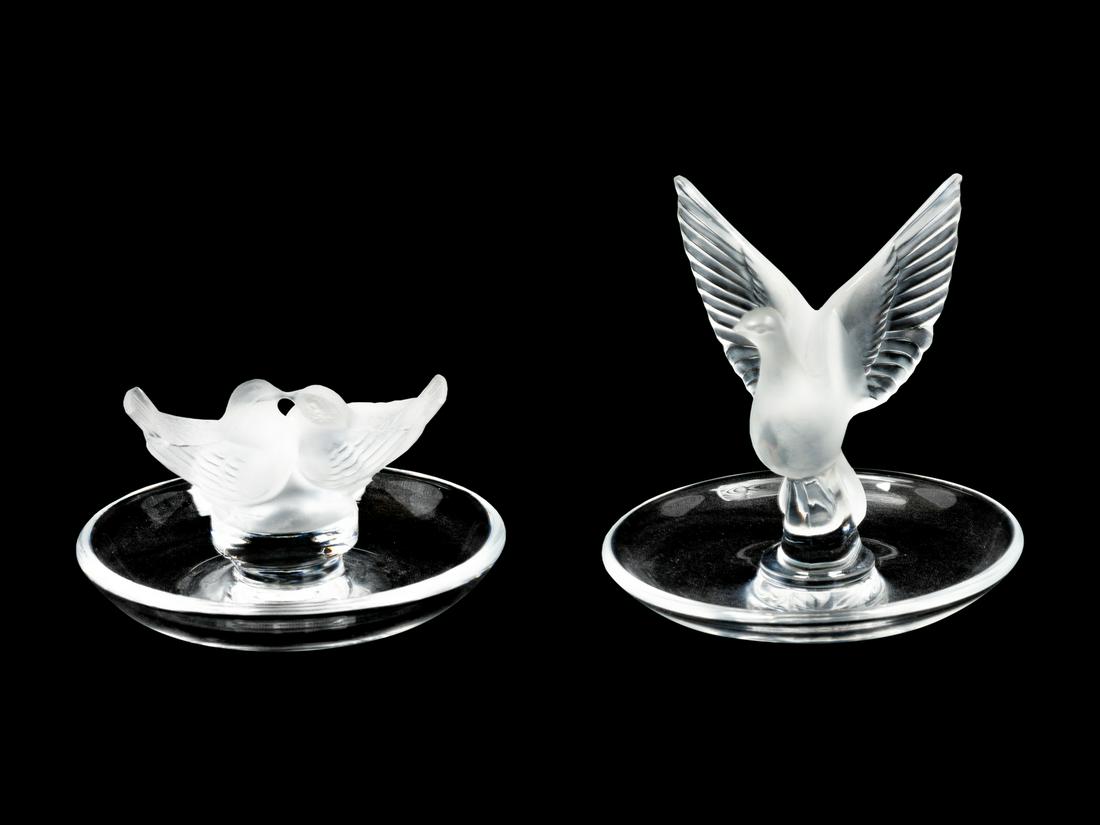 Two Lalique Molded and Frosted Glass Ring Trays Height: Two Lalique Molded and Frosted Glass Ring Trays comprising two bird examples, each signed. Height of taller 3 3/4 inches. Provenance: Property from the Collection of Ann and Steve Bowen, St. Louis, Mi