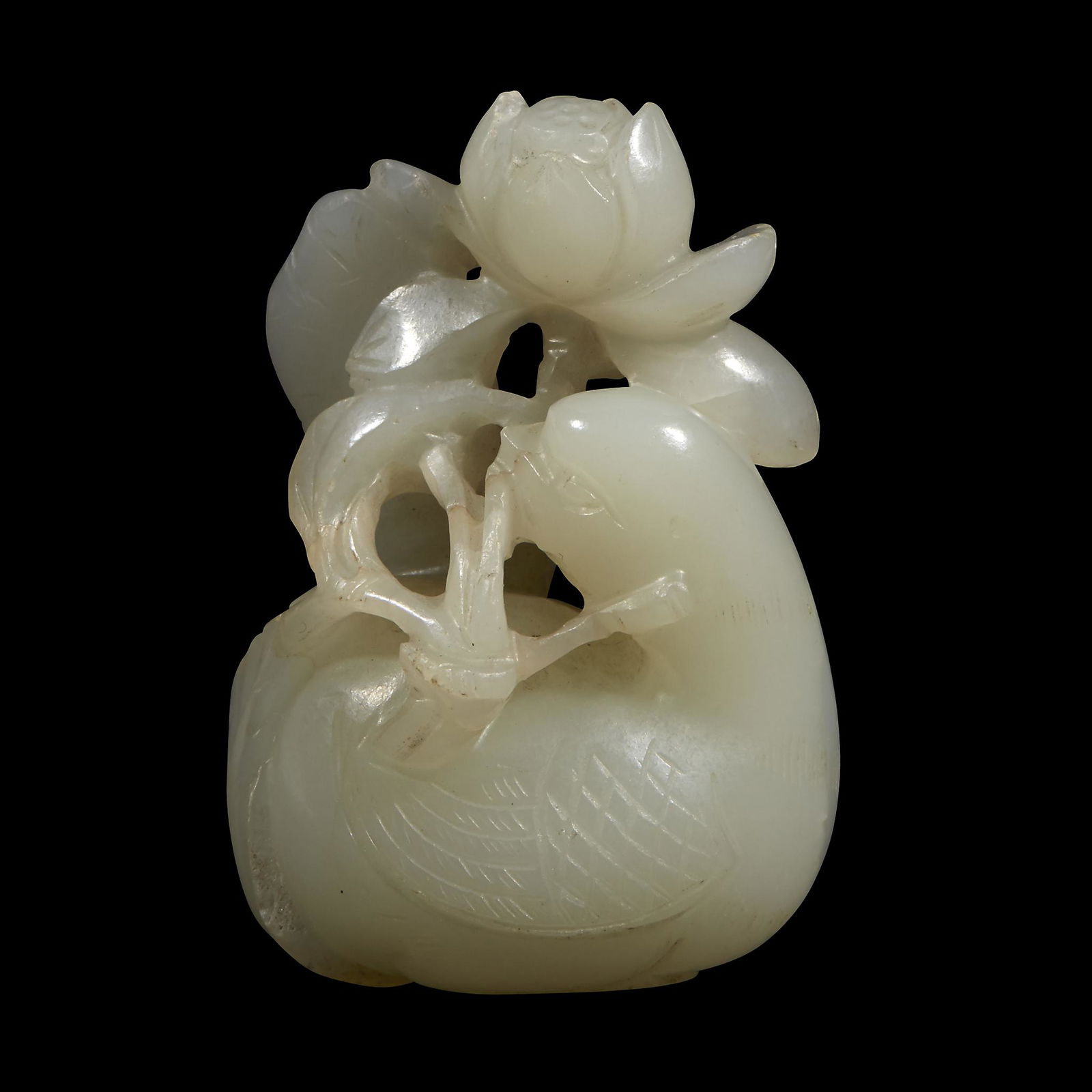 A Chinese white jade carving of a duck bearing a lotus (1 of 3)