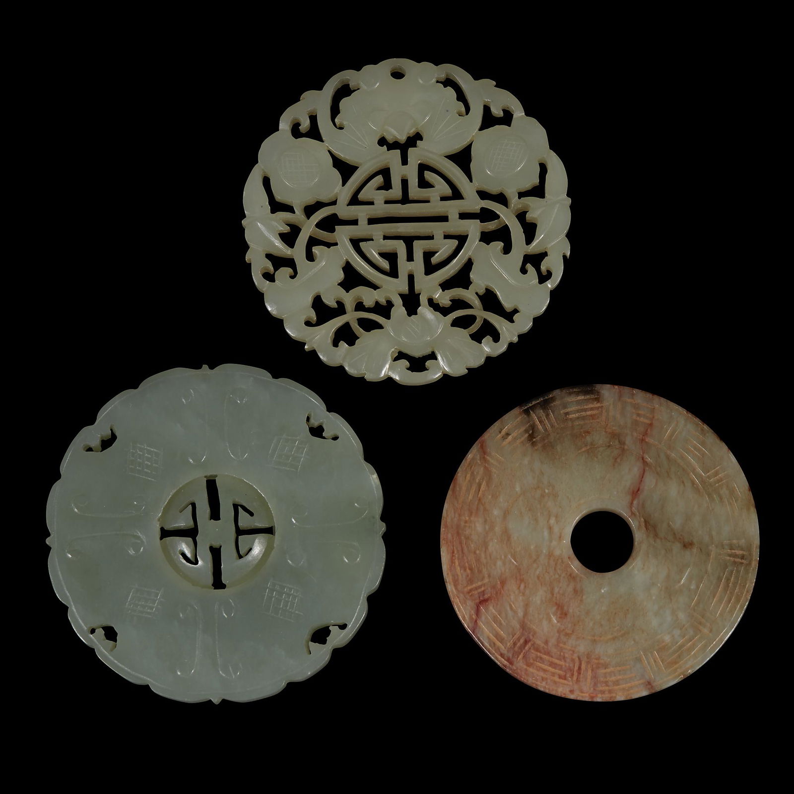 Three Chinese carved jade circular plaques, qing (1 of 2)