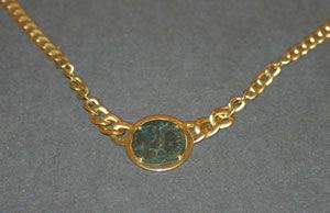 A Lady's 18 Karat Yellow Gold Necklace with an An: A Lady's 18 Karat Yellow Gold Necklace with an Ancient Roman Coin Centerpiece, stamp: Chimento on clasp. 23.00 dwts. Length 16 1/2 inches.