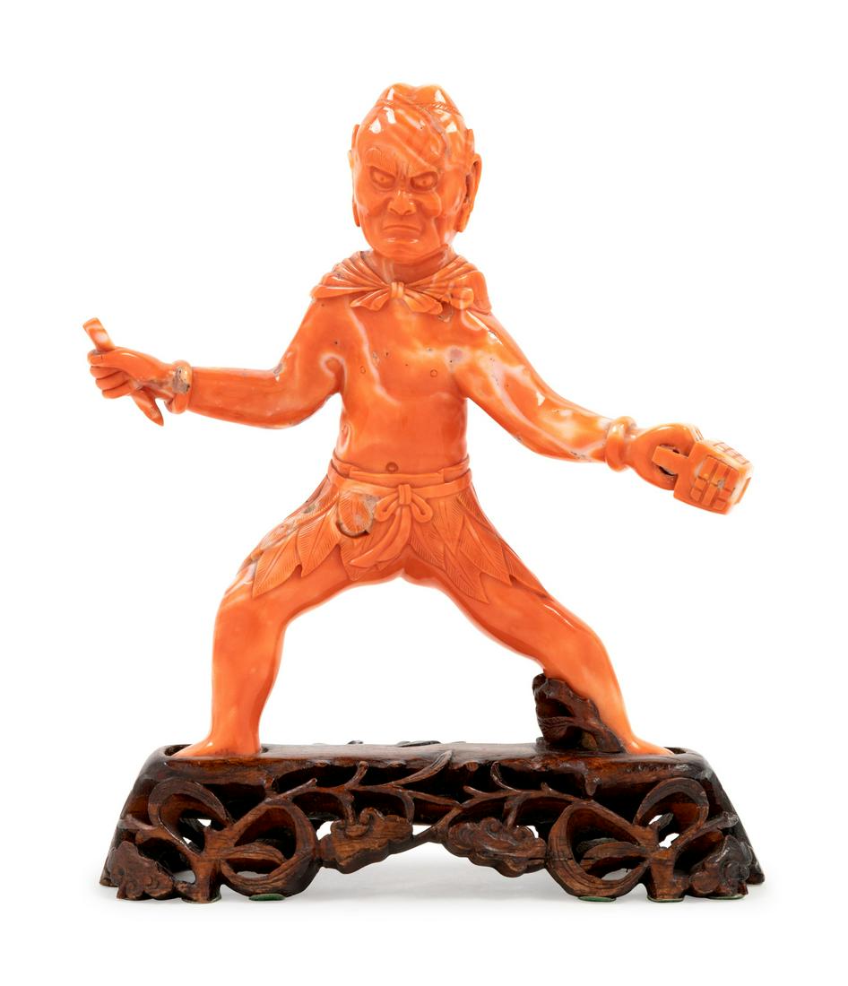 A Carved Coral Figure: A Carved Coral Figure Height of coral 6 7/8 inches. Property from the Collection of Marion and Henry Bloch, Kansas City, Missouri