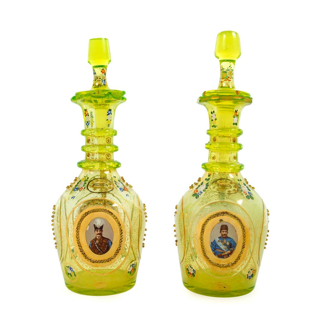 A Pair of Bohemian Enameled Glass Persian Market: A Pair of Bohemian Enameled Glass Persian Market Decanters 19th Century with portraits of Naser al-Din Shah and Mozaffar al-Din Shah. Height 21 inches. Property from the Collection of Hamid and Kim Al