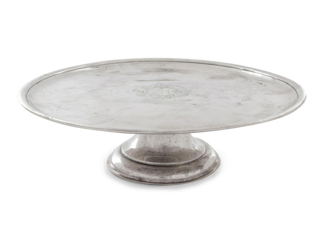 A George I Brittania Silver Cake Dish: A George I Brittania Silver Cake Dish Jos. Ward, London, 1718 having an upturned rim centered with an engraved shield crest. marked on field 29 ozt 14 dwts Height 3 1/2 x diameter 11 3/4 inches.