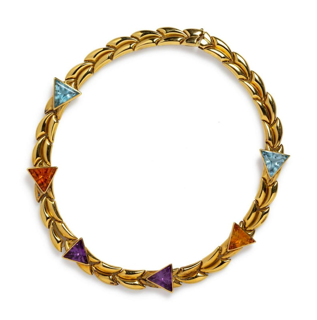 An 18 Karat Yellow Gold and Multigem Collar Necklace,: An 18 Karat Yellow Gold and Multigem Collar Necklace, Chimento, containing two triangular shape amethyst, two triangular shape citrines and two triangular shape blue topaz. Stamp: (Italian hallmark) 7