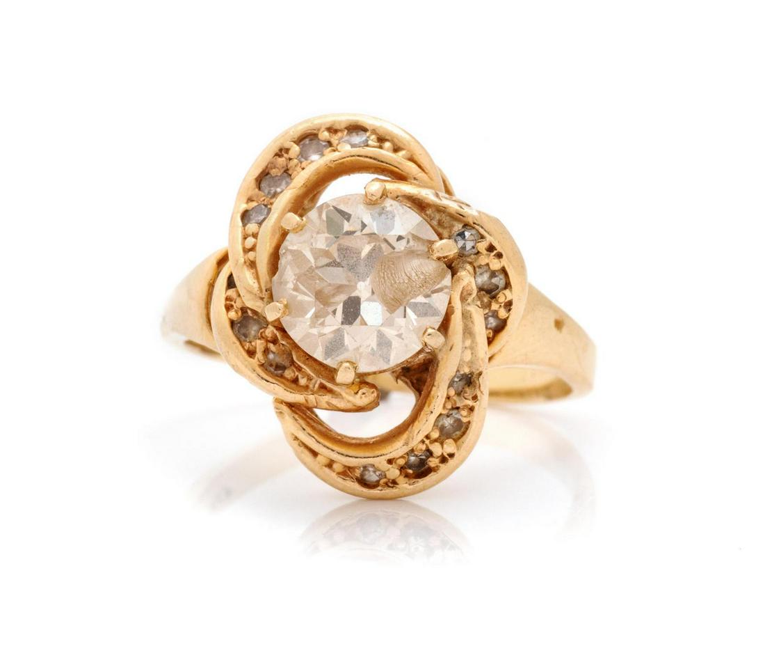 A 14 Karat Yellow Gold and Diamond Ring,: A 14 Karat Yellow Gold and Diamond Ring, containing one round brilliant cut diamond weighing approximately 2.00 carats and 13 single cut diamonds. Stamp: WB 14KP. 4.10 dwts. Provenance: