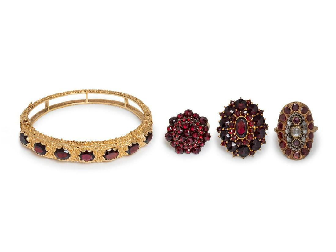 A Collection of Yellow Gold and Garnet Jewelry,: A Collection of Yellow Gold and Garnet Jewelry, consisting of a 14 karat gold bangle bracelet containing seven oval shape mixed cut garnets, a 14 karat ring with applied cluster containing numerous ro