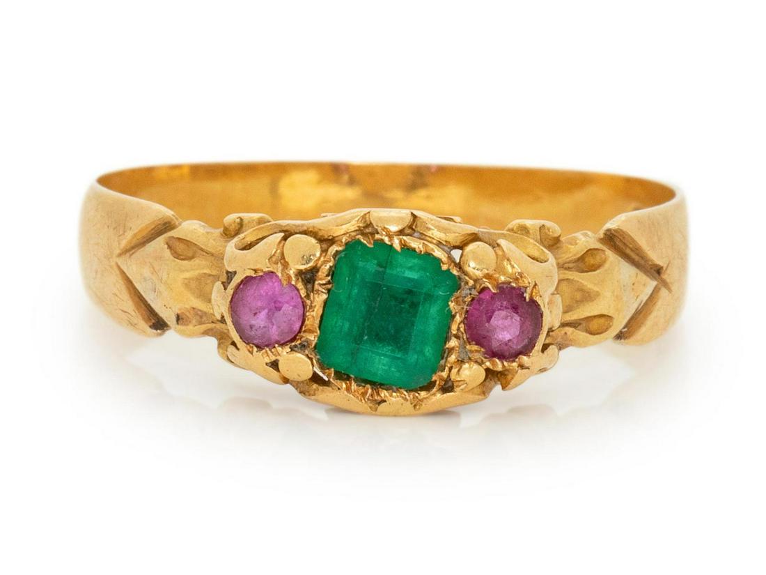An Edwardian 18 Karat Yellow Gold, Emerald and Ruby: An Edwardian 18 Karat Yellow Gold, Emerald and Ruby Ring, containing one square step cut emerald measuring approximately 3.97 x 3.60 mm and two round mixed cut rubies. Stamp: (British hallmarks). 2.70