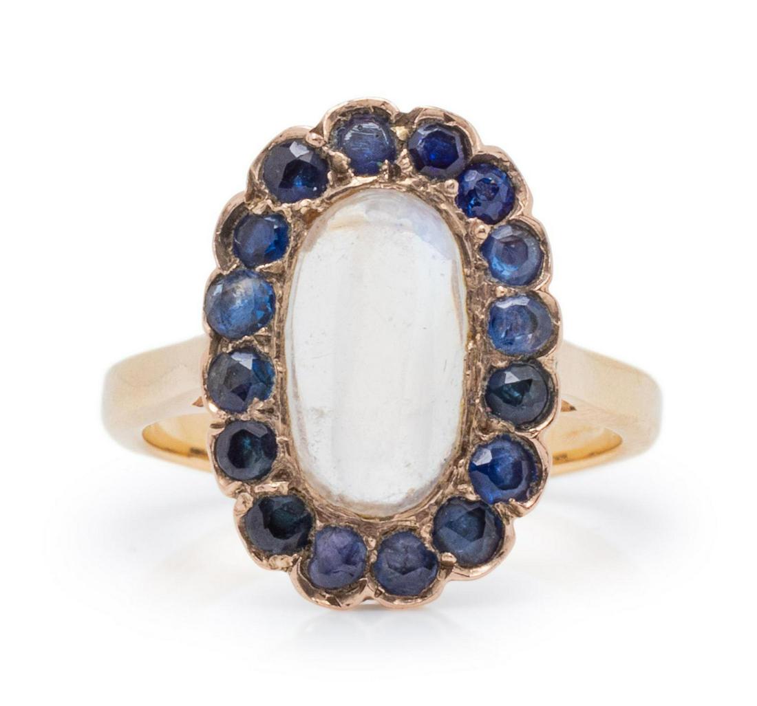 An Antique 14 Karat Yellow Gold, Moonstone and Sapphire: An Antique 14 Karat Yellow Gold, Moonstone and Sapphire Ring, containing one oval cabochon cut moonstone measuring approximately 10.90 x 6.10 mm and 16 round mixed cut sapphires. Stamp: 14K. 1.10 dwts