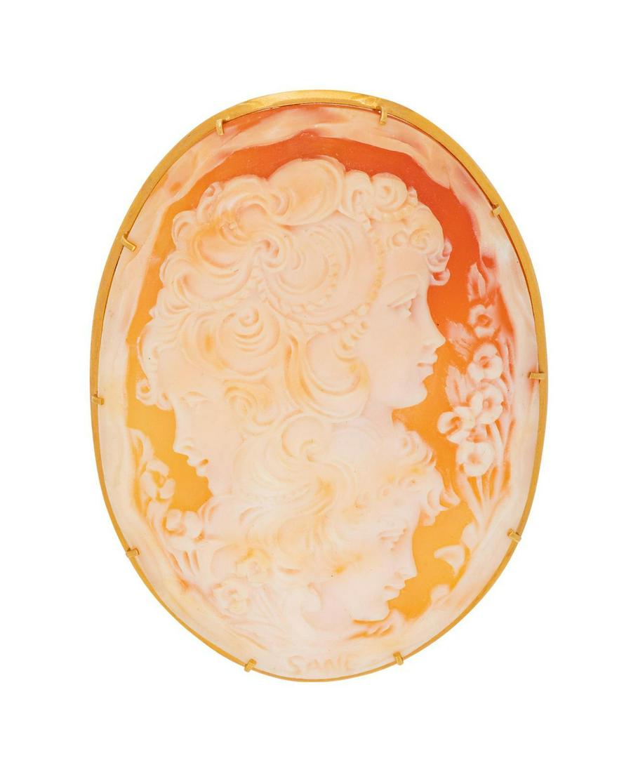 An 18 Karat Yellow Gold and Shell Cameo Brooch, : An 18 Karat Yellow Gold and Shell Cameo Brooch, depicting three female profiles with a yellow gold mounting. Stamp: (Italian assay mark) 750. 12.30 dwts. Provenance: Property of an Important Midwest