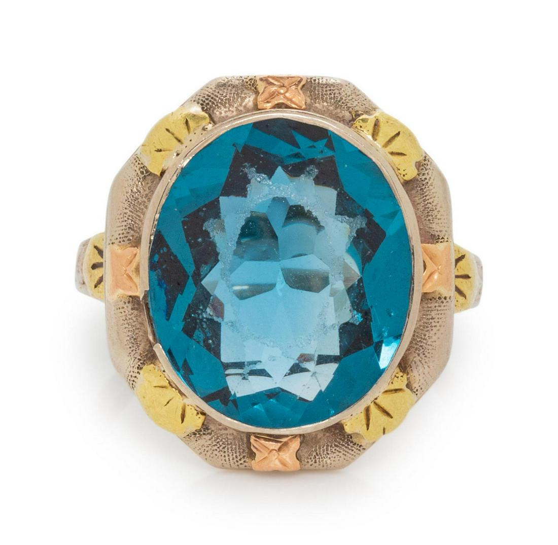 A 14 Karat Tricolor Gold and Synthetic Blue Spinel: A 14 Karat Tricolor Gold and Synthetic Blue Spinel Ring, LaFrance, containing one oval mixed cut synthetic spinel measuring approximately 13.95 x 11.79 mm. Stamp: LaFrance 14K. 3.80 dwts. Provenance:
