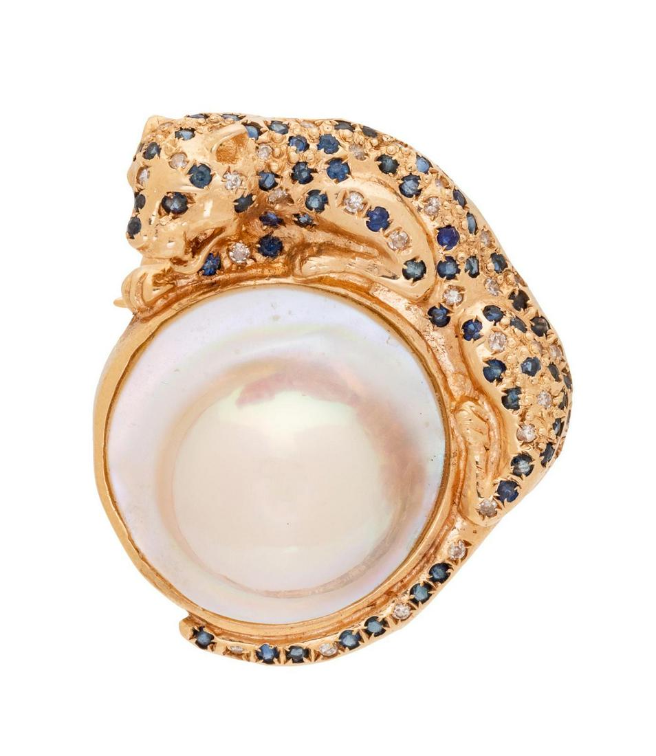 A 14 Karat Yellow Gold, Cultured Mabe Pearl, Sapphire: A 14 Karat Yellow Gold, Cultured Mabe Pearl, Sapphire and Diamond Panther Pendant/Brooch, containing one mabe pearl measuring approximately 19.00 mm and numerous round mixed cut sapphires and round br
