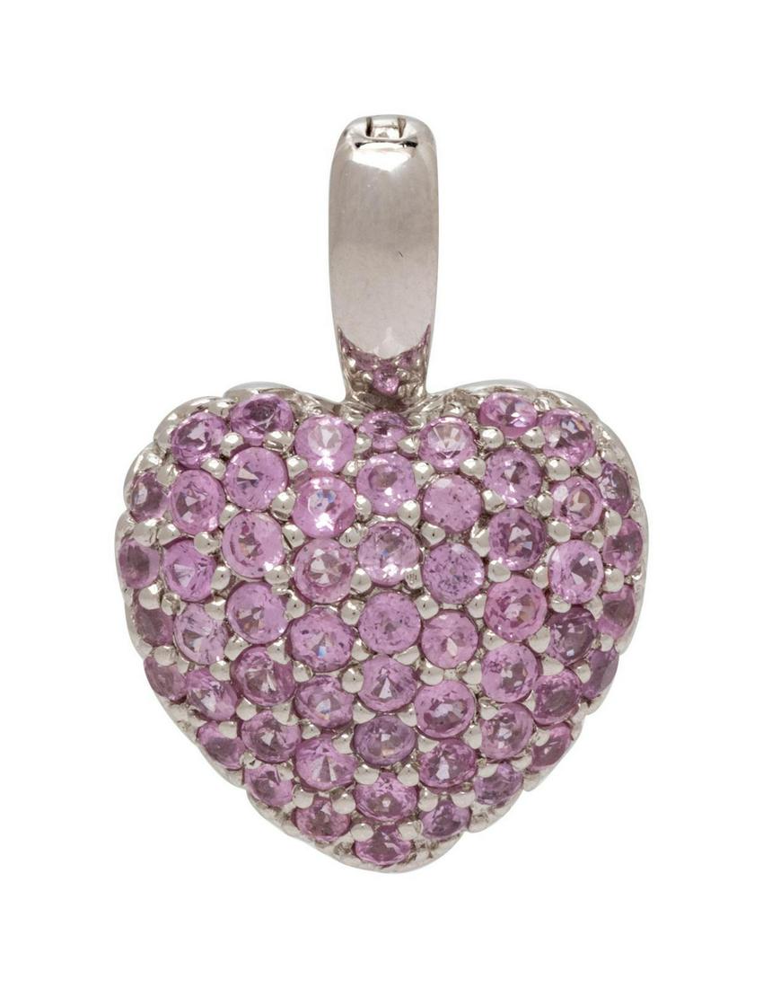 A 14 Karat White Gold and Pink Sapphire Heart Pendant,: A 14 Karat White Gold and Pink Sapphire Heart Pendant, containing 56 round mixed cut pink sapphires measuring approximately 2.00 mm in diameter. Stamp: STS 14K. 2.30 dwts. Provenance: