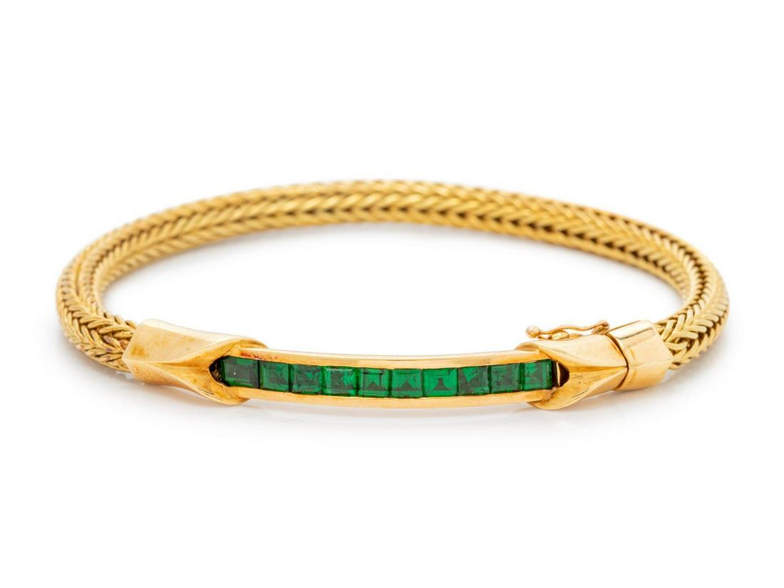An 18 Karat Yellow Gold and Tsavorite Bracelet, : An 18 Karat Yellow Gold and Tsavorite Bracelet, containing 10 square step cut tsavorites measuring approximately 3.00 x 3.00 mm. Stamp: R R 18K. 17.85 dwts. Provenance: