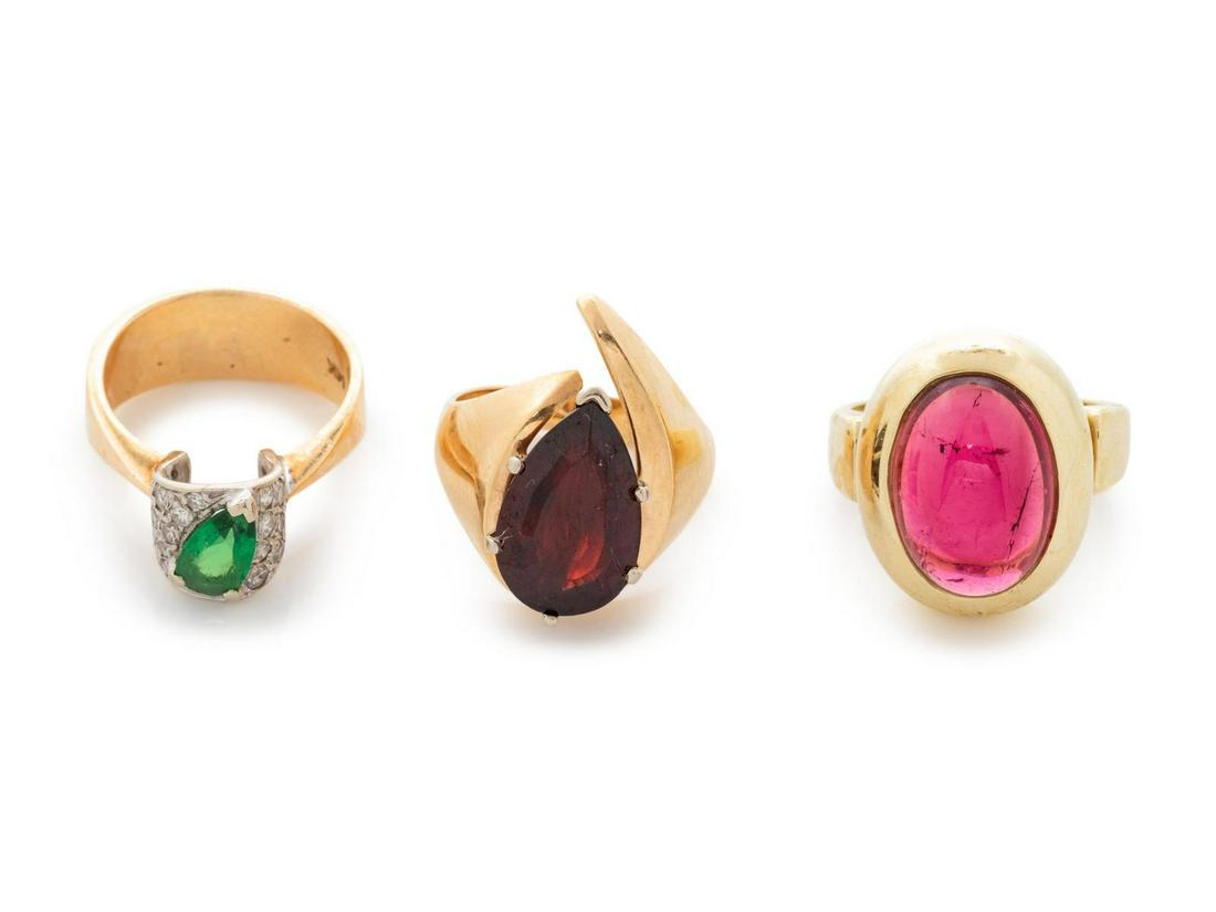 A Collection of 14 Karat Yellow Gold and Gemstone: A Collection of 14 Karat Yellow Gold and Gemstone Rings, consisting of a ring containing one oval shape cabochon cut pink tourmaline, a ring containing one pear shape garnet, together with a ring cont