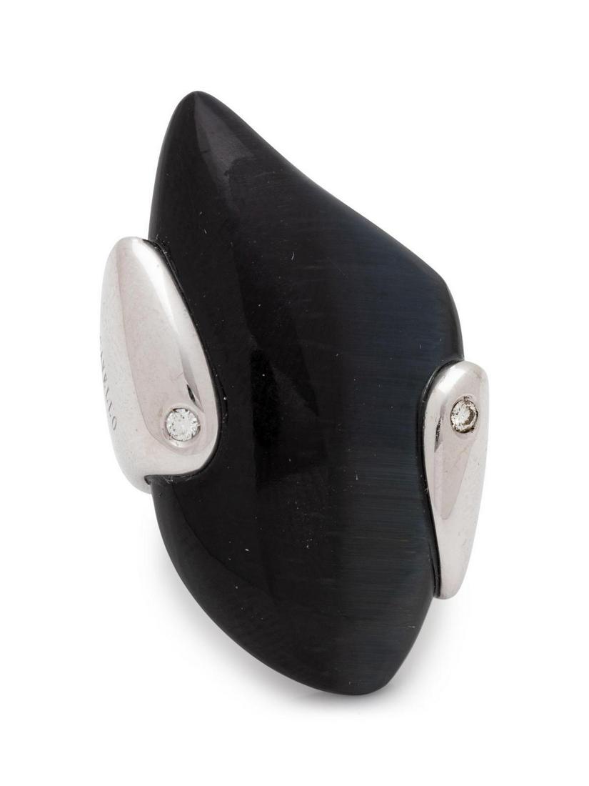 An 18 Karat White Gold, Diamond and Hardstone Ring,: An 18 Karat White Gold, Diamond and Hardstone Ring, Gavello, containing one freeform black hardstone and two round brilliant cut diamonds weighing approximately 0.05 carat total. Stamp: GAVELLO (maker