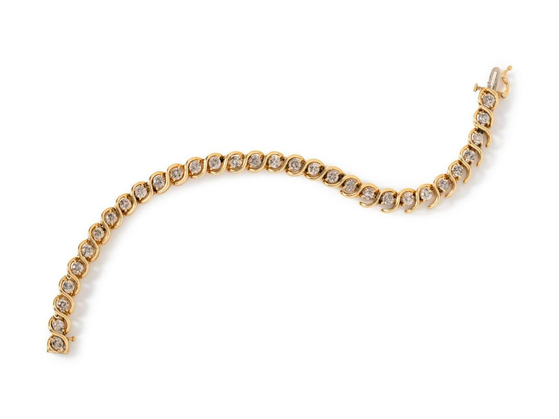 A 14 Karat Yellow Gold and Diamond Bracelet,: A 14 Karat Yellow Gold and Diamond Bracelet, containing 31 round brilliant cut diamonds weighing approximately 5.00 carats total. Stamp: JAFA 5TW 14K. 10.60 dwts. Provenance: